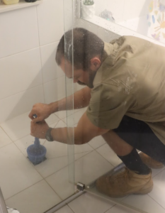 Matt unclearing drain Blocked drain. Slow to drain shower